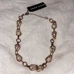 This is an Anne Klein gold-tone and faux pearl link necklace.